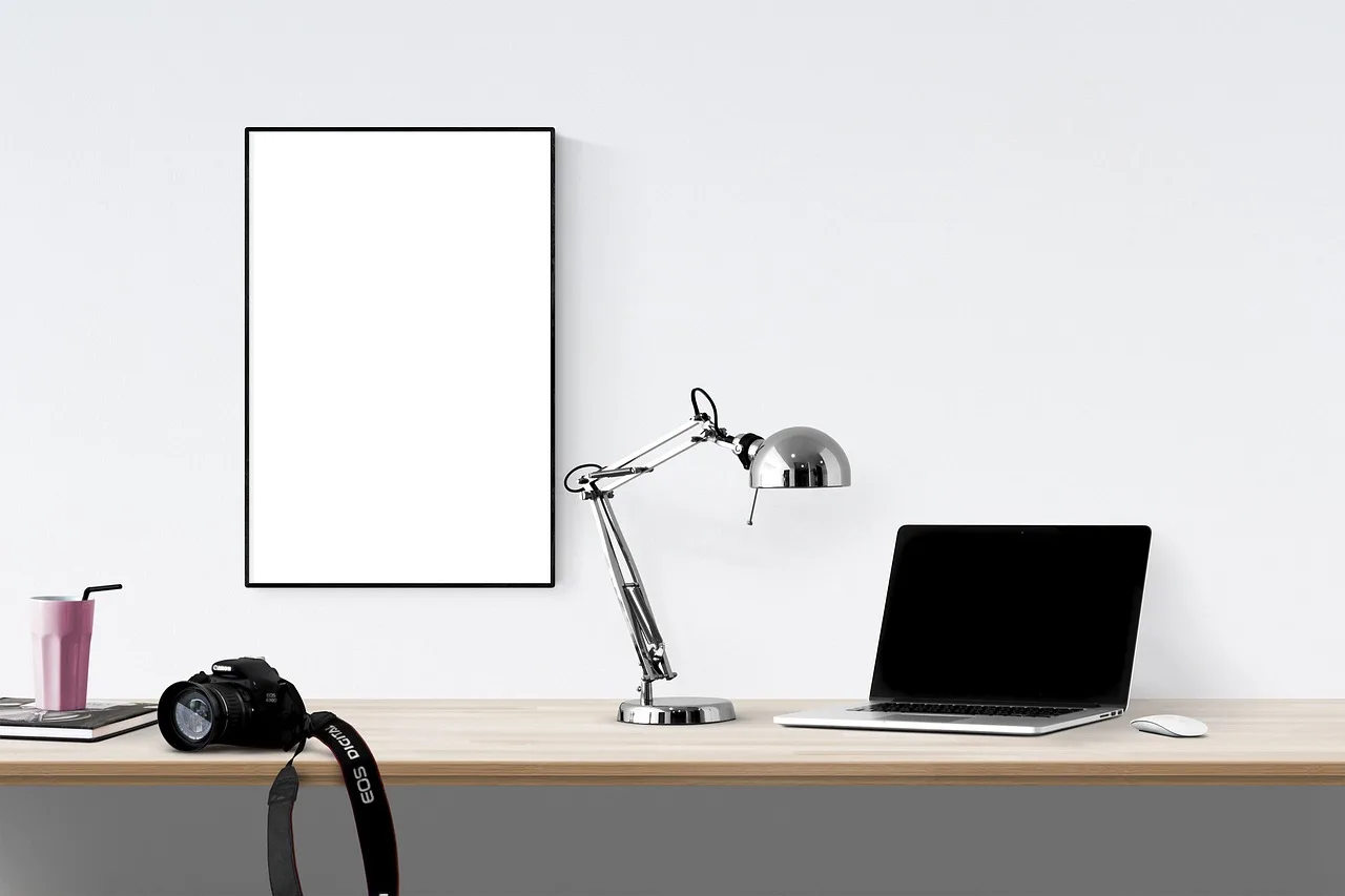 poster, frame, laptop, camera, desk, poster, frame, frame, frame, frame, frame, laptop, laptop