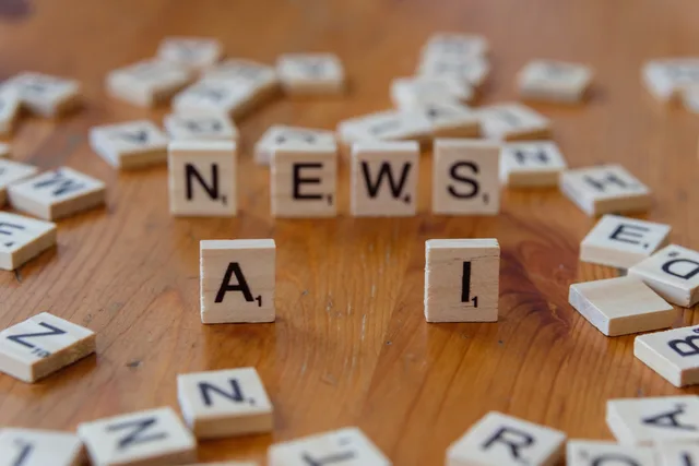 Wooden Scrabble tiles spelling 'AI' and 'NEWS' for a tech concept image. What an AI content operations review methodology means for buyers
